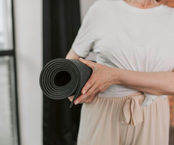 Close up of a man's hands performing a balance exercise on a mat.